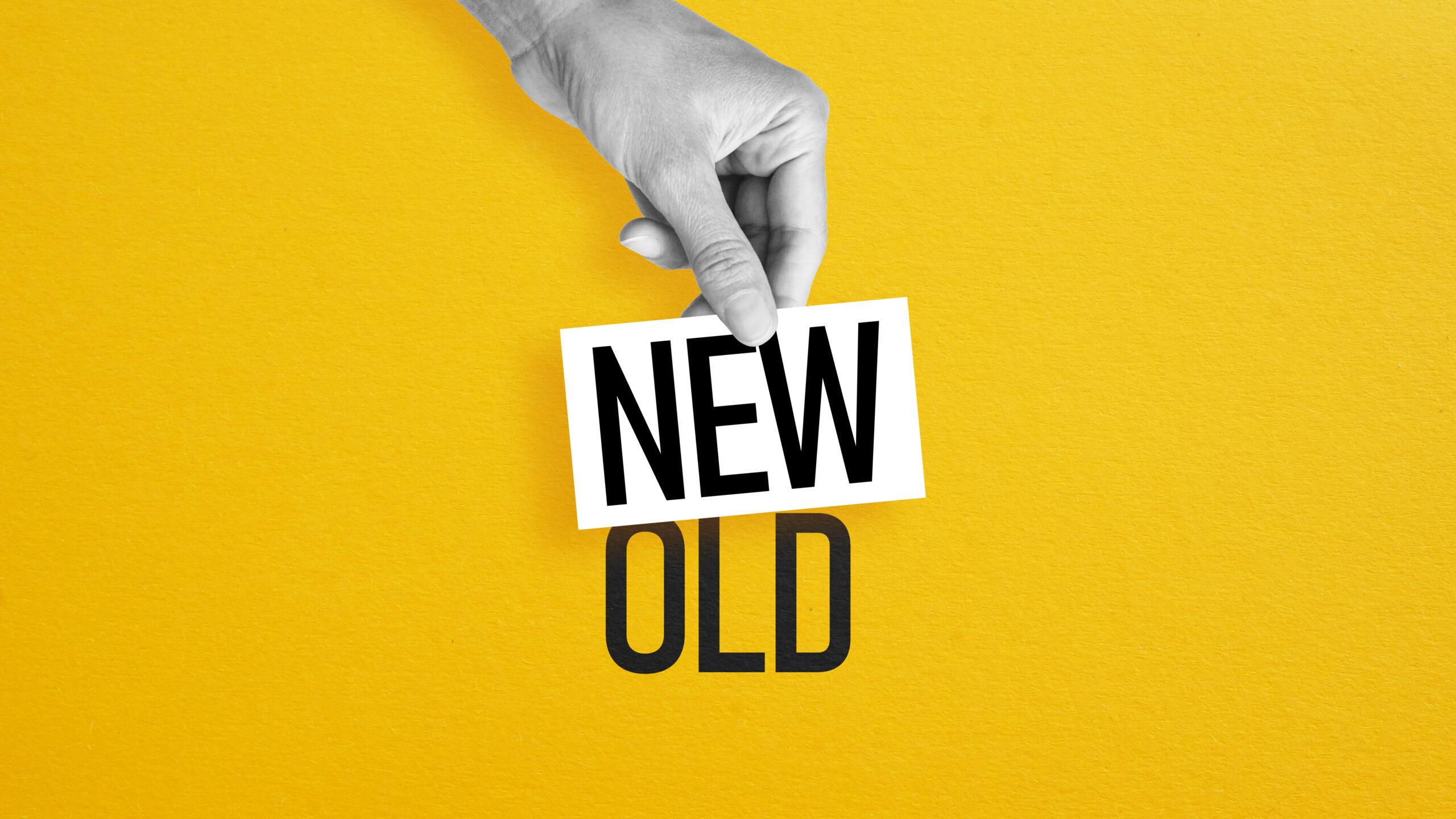 Hand replacing the word old with new to represent business rebranding and brand transformation